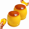 Two large Pudding Squishy Balls with hands demonstrating stretching and squeezing