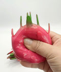 Dragon Fruit Squishy being squeezed with one hand - showing deformation