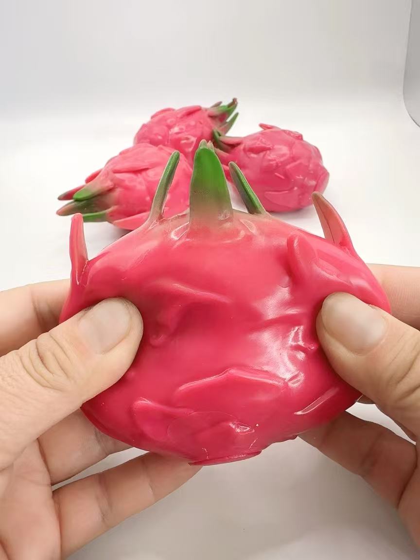 Dragon Fruit Squishy being held with both hands from above