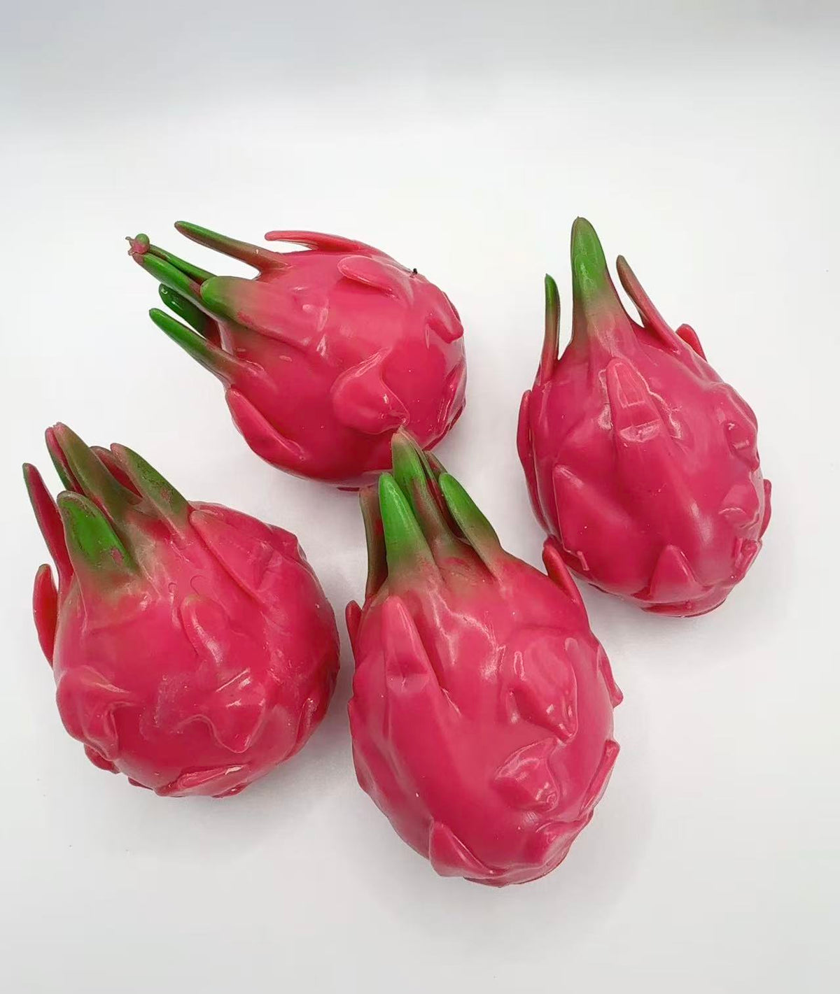 Four Dragon Fruit Squishies on white background - product flat lay